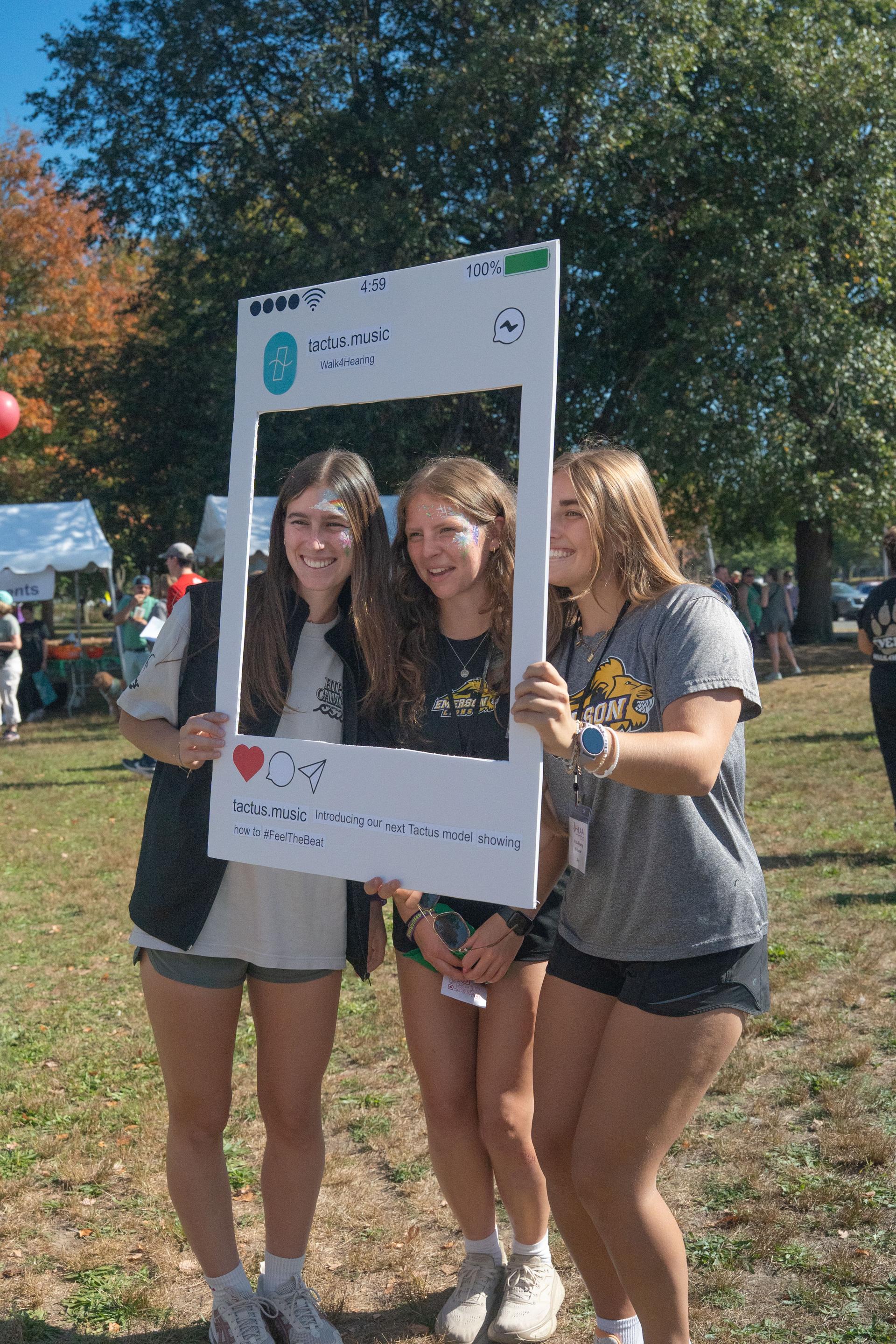 Three students holding a Tactus Instagram frame at a Walk4Hearing community program
