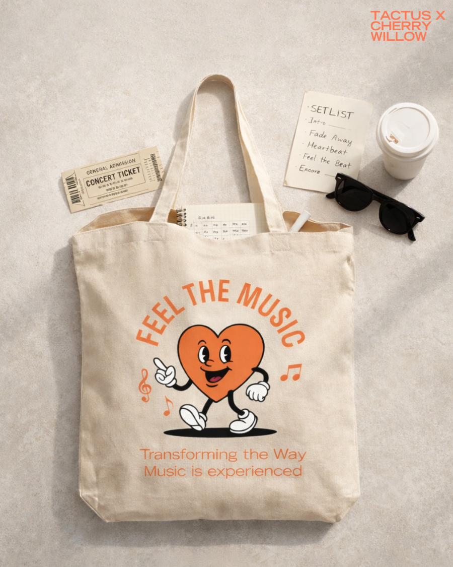 Natural canvas CWA × Tactus "Feel the Music" tote bag styled with a concert ticket, setlist and coffee cup
